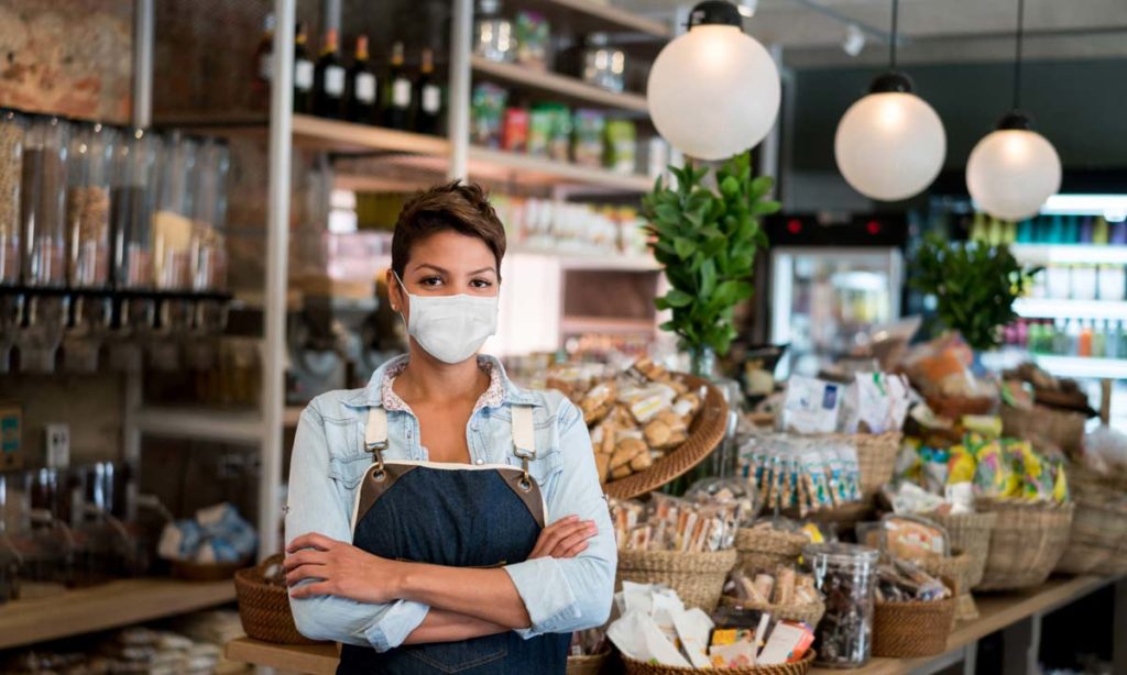 Store owner in front of products