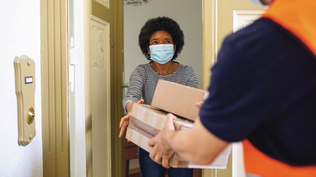 Woman receiving a package from delivery person