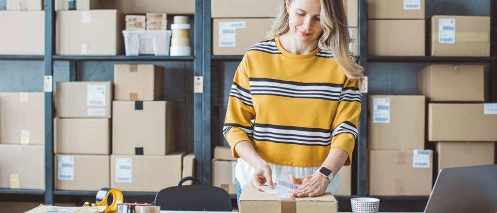 Merchant preparing package for shipping