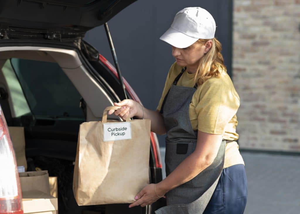 Woman loading trunk for curbside pickup